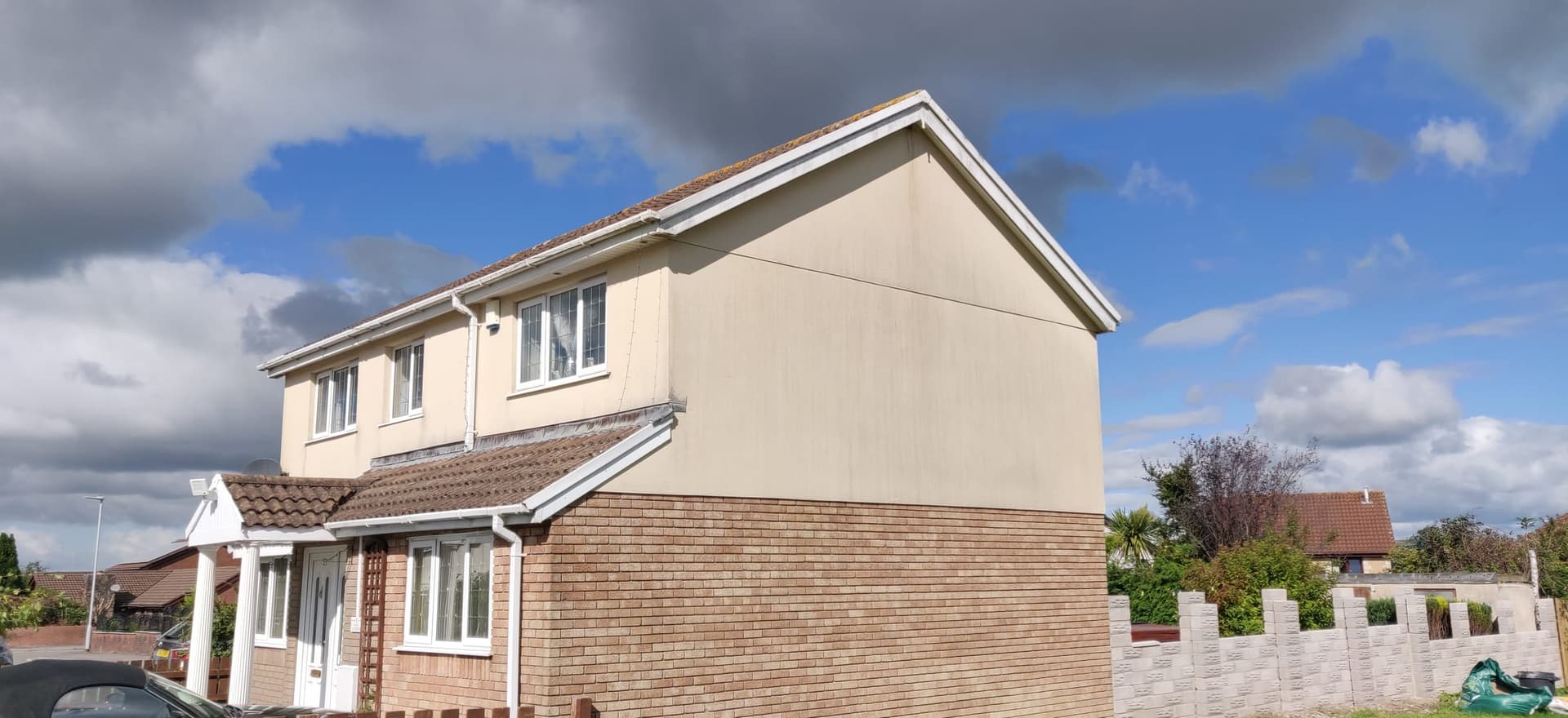 A rendered semi-detached house in Swansea after a soft wash, render and roofline cleaned